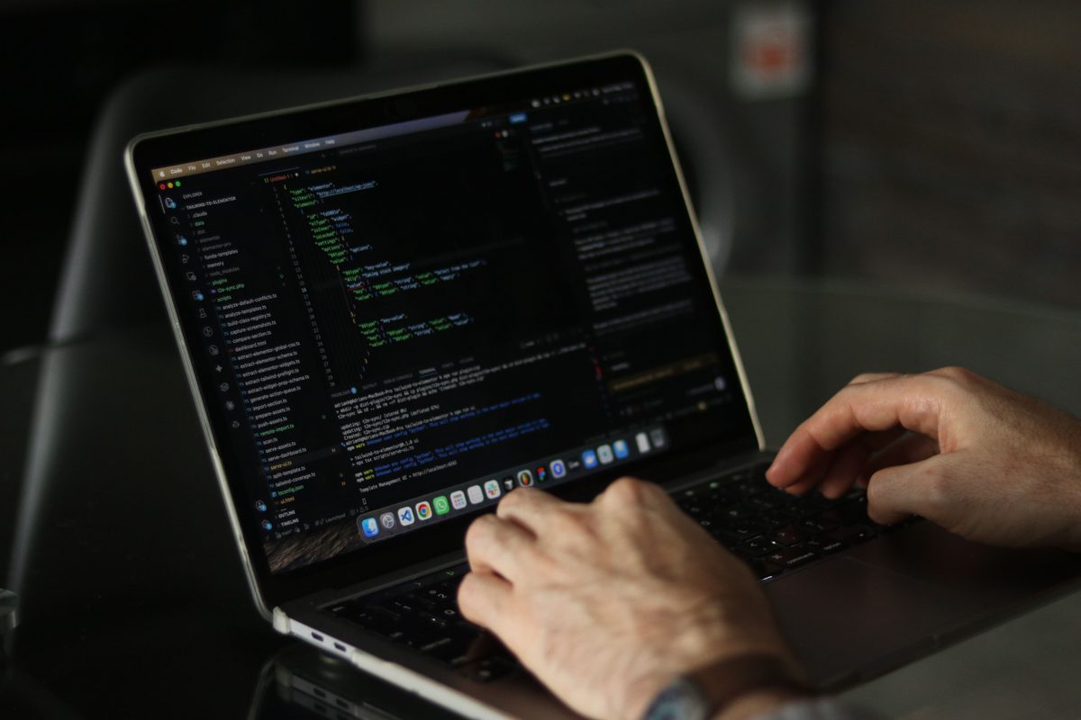 Reviewing AI-generated code on a laptop screen to catch quality and security issues