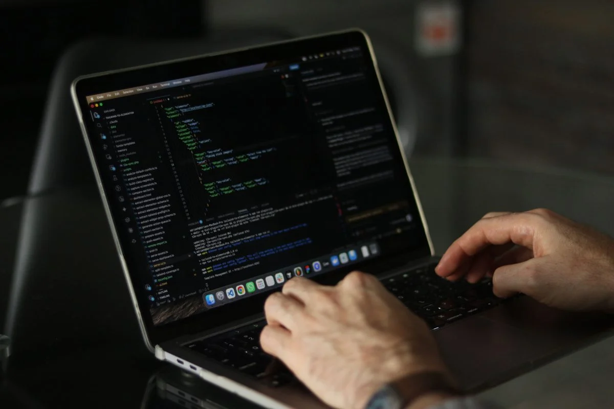 Reviewing AI-generated code on a laptop screen to catch quality and security issues