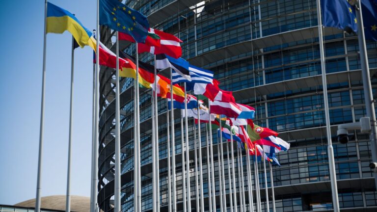 European Union flags outside a modern building