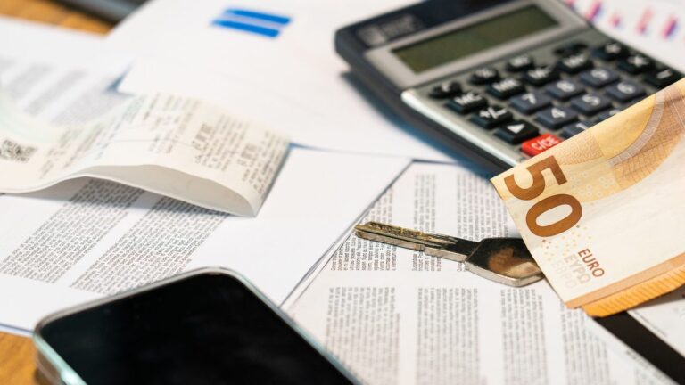 Calculator and euro banknote on budget planning documents