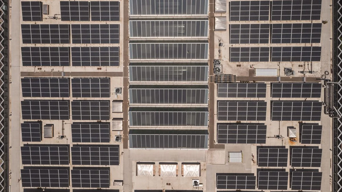 Aerial drone view of a rooftop solar panel array during a thermal inspection